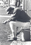 Member of the Chapman College baseball team sitting on the bench