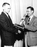 Bob Hamblin accepting a trophy from Don Perkins, Chapman College, Orange, California