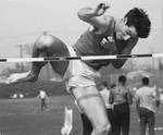 Track team member jumps hurdle, Chapman College, Orange, California, 1966