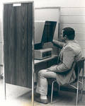 Using a microfilm reader in the Thurmond Clarke Memorial Library, Chapman College, Orange, California