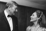John Wayne is in conversation with his wife, Pilar Wayne at the Chapman College Challenge '70 Dinner, 1970