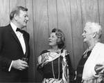 John Wayne with Mrs. Barry Goldwater and Mrs. Harry Carey at the Chapman College Challenge '70 Dinner