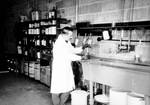 Technician mixing photographic chemicals